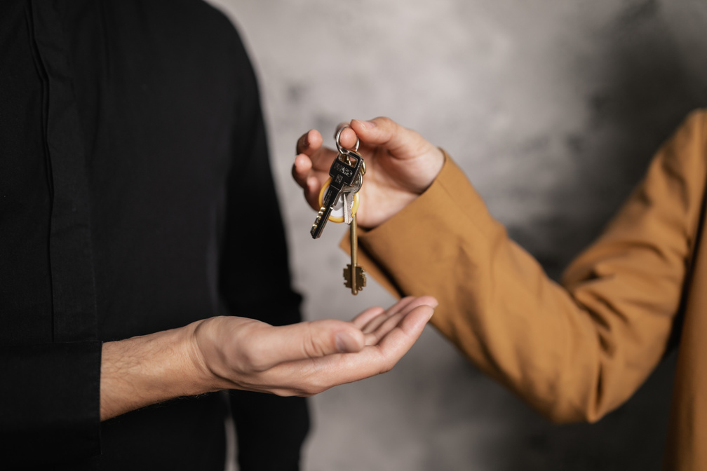  A Person Giving a Bundle of Keys to another Person